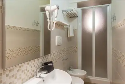 a bathroom with a sink and a shower with a mirror at A casa di Rosanna in Rome