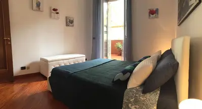 a bedroom with a bed with a green comforter at Il giardino nascosto in Rome