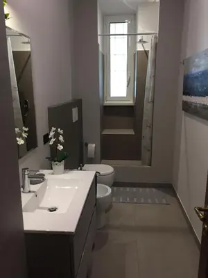 a bathroom with a sink and a toilet and a shower at Il giardino nascosto in Rome