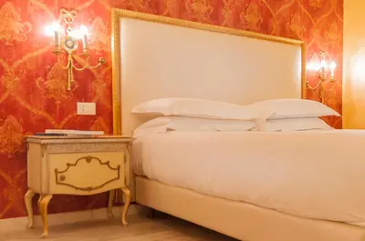 a bedroom with a bed and a side table at Ripetta Rooms in Rome