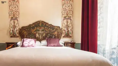 a bedroom with a large bed with purple pillows at Ripetta Rooms in Rome