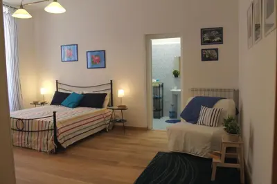 a bedroom with a bed and a chair in it at Home 103 in Rome