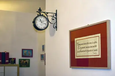 a clock hanging on a wall next to a picture at Home 103 in Rome