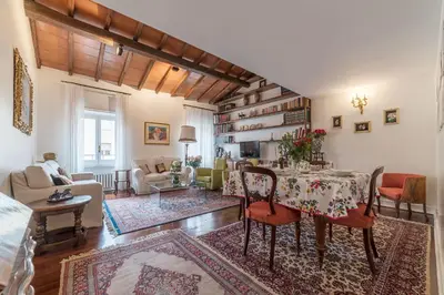 a living room with a table and chairs and a living room at Quiet and classic on two floors, by Trevi Fountain - FromHometoRome in Rome