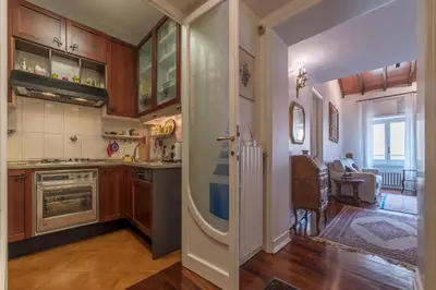 a kitchen with a door leading to a dining room at Quiet and classic on two floors, by Trevi Fountain - FromHometoRome in Rome