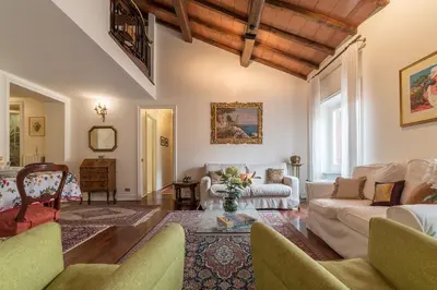 a living room with white furniture and a wooden ceiling at Quiet and classic on two floors, by Trevi Fountain - FromHometoRome in Rome
