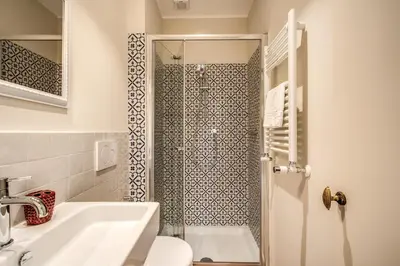 a bathroom with a shower with a sink and a toilet at Roof top dream piazza del popolo in Rome