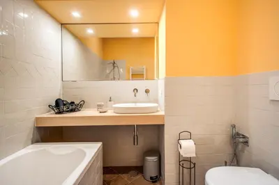 a bathroom with a sink and a tub and a toilet at Roof top dream piazza del popolo in Rome