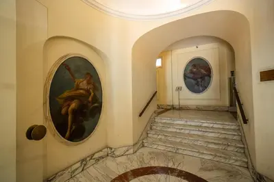 a hallway in a building with paintings on the walls at Roof top magic Piazza del Popolo in Rome