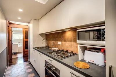 a kitchen with a stove and a microwave at Roof top magic Piazza del Popolo in Rome