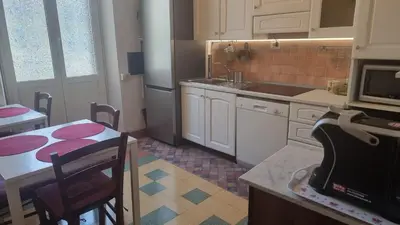 a kitchen with a table and a sink and a stove at Anthony Guesthouse in Rome