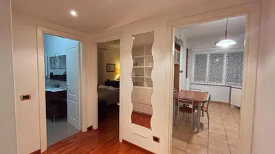 a kitchen and dining room with a table and a room at FG St Peter's Suites in Rome