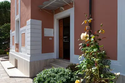 a front door of a house with a plant at I Villini del Pigneto in Rome