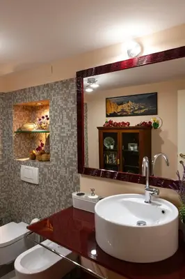 a bathroom with a sink and a mirror at I Villini del Pigneto in Rome
