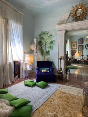 a living room with a blue couch and green pillows at Rome Museum House in Rome