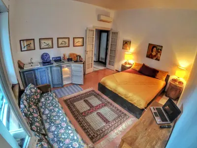 an aerial view of a bedroom with a bed and a couch at Rome Museum House in Rome
