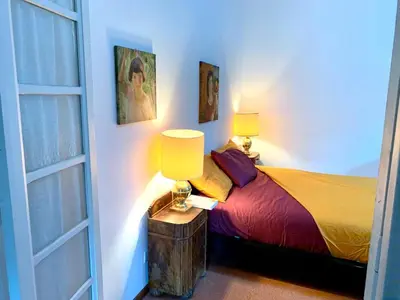 a bedroom with a bed with two lamps on a table at Rome Museum House in Rome