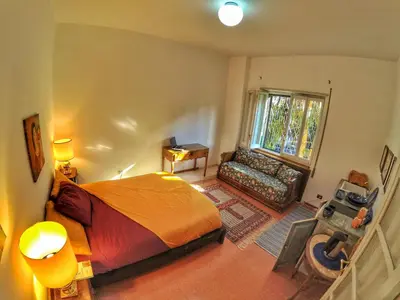 a bedroom with a bed and a desk and a window at Rome Museum House in Rome