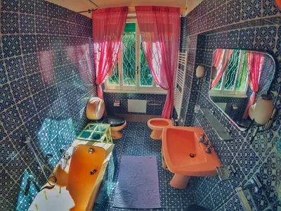 an aerial view of a bathroom with a sink and toilets at Rome Museum House in Rome