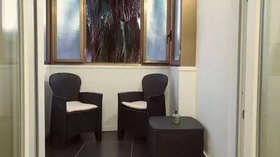a row of chairs in a room with windows at Efeso 19 in Rome
