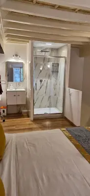 a large bathroom with a shower and a sink at Coronari 45 apartment in Rome