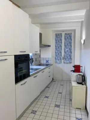 a kitchen with white cabinets and a tile floor at Coronari 45 apartment in Rome