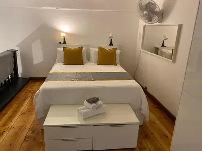 a small bedroom with two beds and a mirror at Coronari 45 apartment in Rome