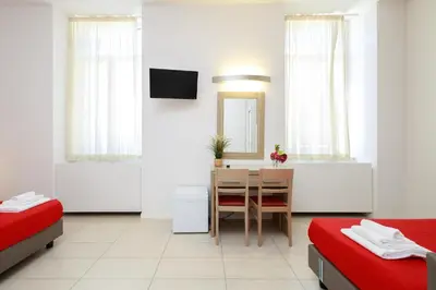 a room with a table and a dining room at San Luigi - Residenza Gemelli in Rome