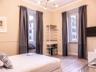 a bedroom with a bed and two windows at Vatican Palace Suites by Premium Suites Collection in Rome