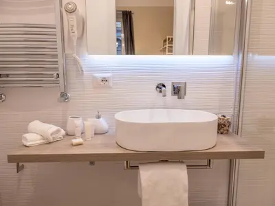 a bathroom with a white sink and a mirror at Vatican Palace Suites by Premium Suites Collection in Rome