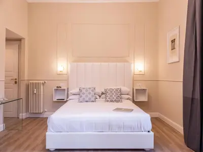 a bedroom with a large white bed with two pillows at Vatican Palace Suites by Premium Suites Collection in Rome