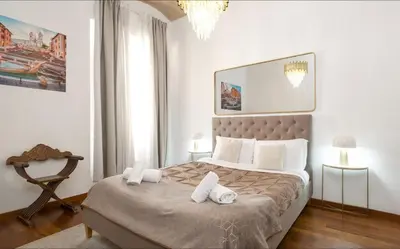 a bedroom with a large bed with two towels on it at DrsRome - Roman's Ruins Colosseum in Rome