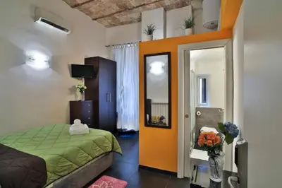 a bedroom with a green bed and a mirror at Rome Place in Rome