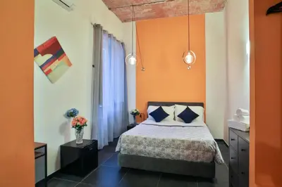 a bedroom with a bed with an orange wall at Rome Place in Rome