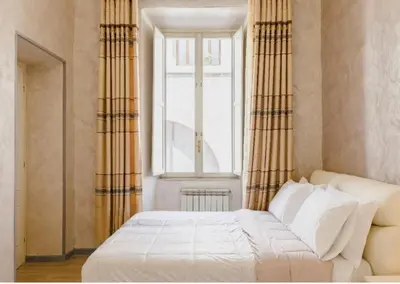 a bedroom with a white bed and a window at Rome Place in Rome