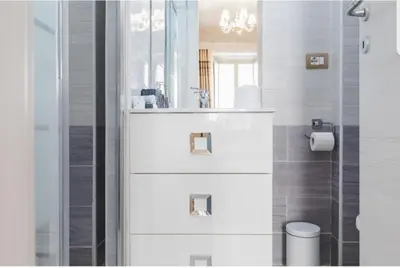 a white bathroom with a sink and a mirror at Rome Place in Rome