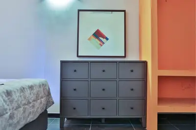 a bedroom with a dresser and a picture on the wall at Rome Place in Rome