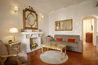 a living room with a couch and a fireplace at Condotti Corner Apartment Piazza di Spagna in Rome