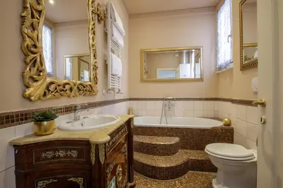 a bathroom with a tub and a toilet and a sink at Condotti Corner Apartment Piazza di Spagna in Rome
