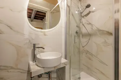 a bathroom with a sink and a shower at Condotti Corner Apartment Piazza di Spagna in Rome