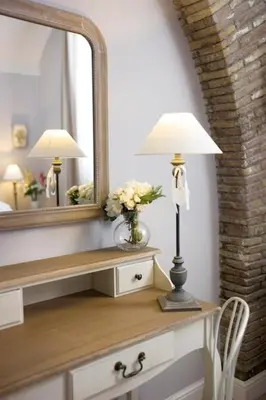 a lamp on a dresser in a room with a mirror at DD Luxury House in Rome