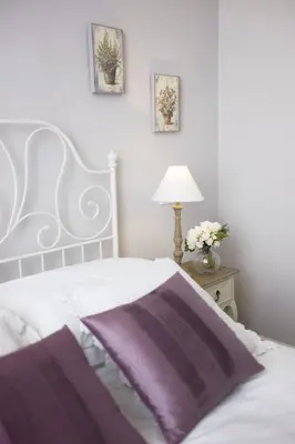 a bedroom with a white bed with a purple blanket at DD Luxury House in Rome
