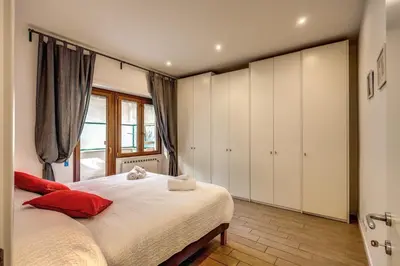 a bedroom with a bed with white cabinets and a window at M&L Apartment - Ardesia Terrace in Rome