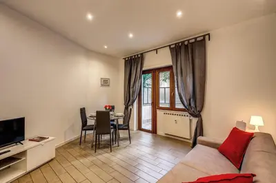 a living room with a couch and a table at M&L Apartment - Ardesia Terrace in Rome