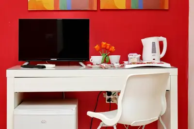 a white desk with a television and a white chair at Affittacamere Alessia&Calliope in Rome