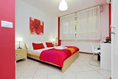 a bedroom with a bed and a desk and a window at Affittacamere Alessia&Calliope in Rome