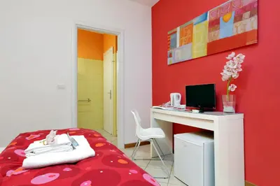a room with a bed and a desk with a computer at Affittacamere Alessia&Calliope in Rome