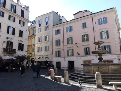a group of people walking down a street next to a fountain at Boschetto Monti Apartment in Rome
