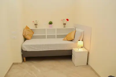 a small bedroom with a bed with two pillows at DOMUS DIVI - appartamento nel cuore di Roma in Rome