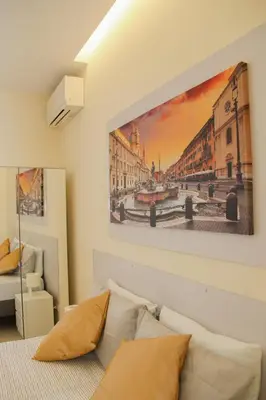 a living room with a couch and a painting on the wall at DOMUS DIVI - appartamento nel cuore di Roma in Rome